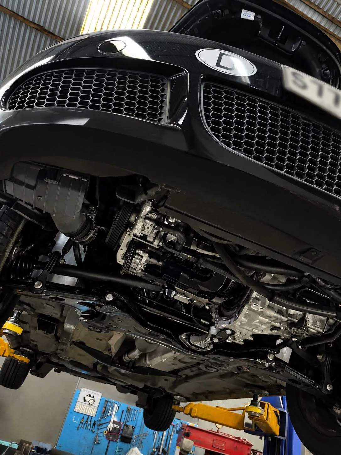 Front suspension and steering components seen from underneath a raised vehicle