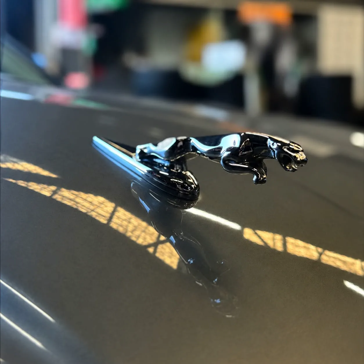 The leaping jaguar bonnet ornament on a Jaguar in the workshop