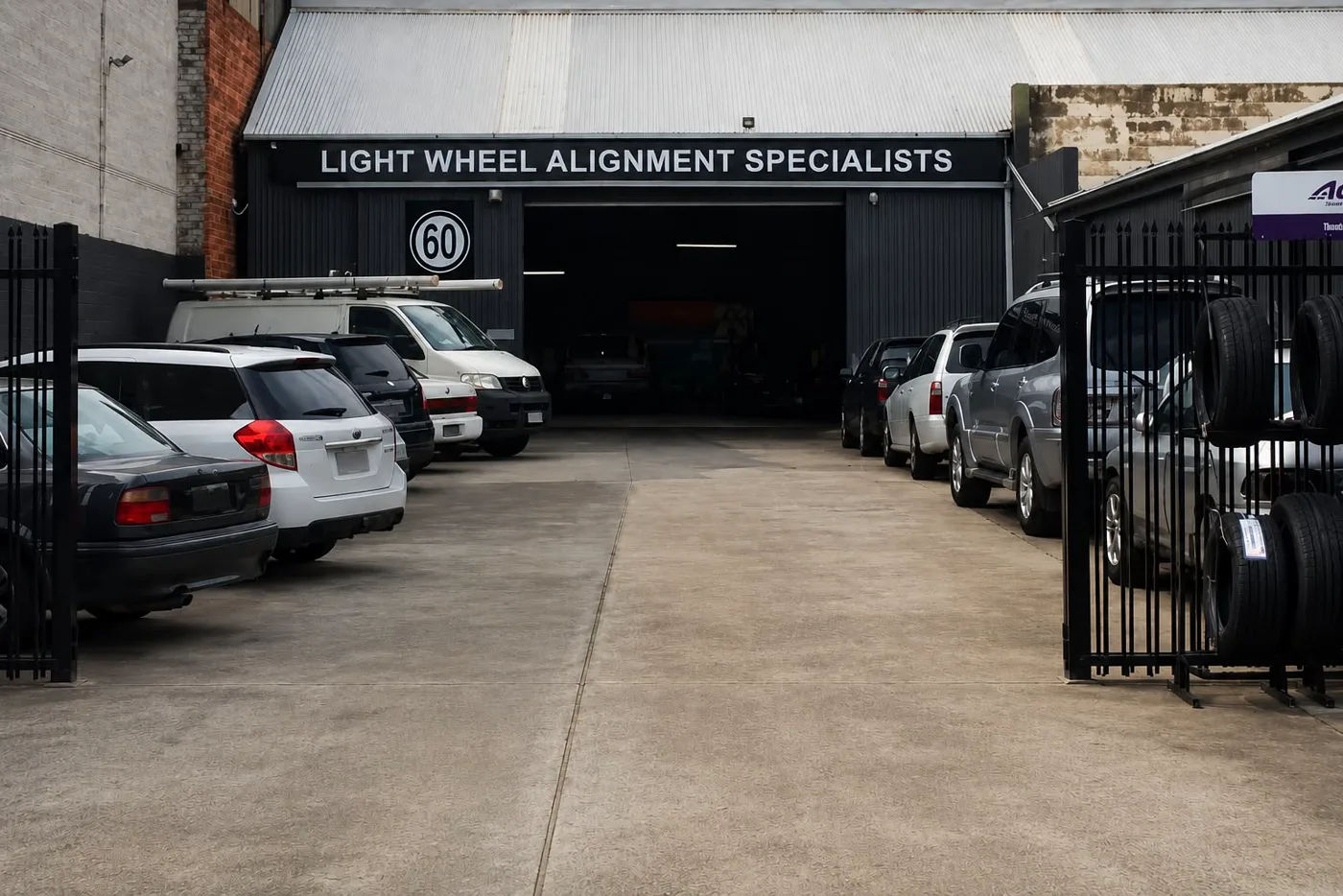The Light Wheel Alignment Specialists frontage at 60 Byron Place with customer cars parked outside