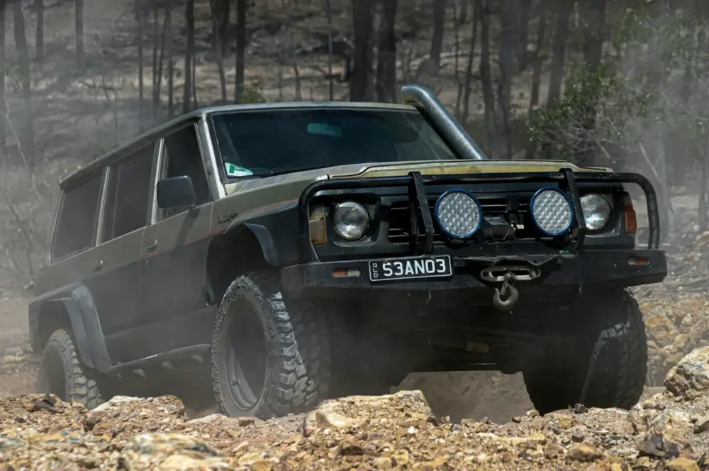 A lifted four wheel drive parked outside the workshop